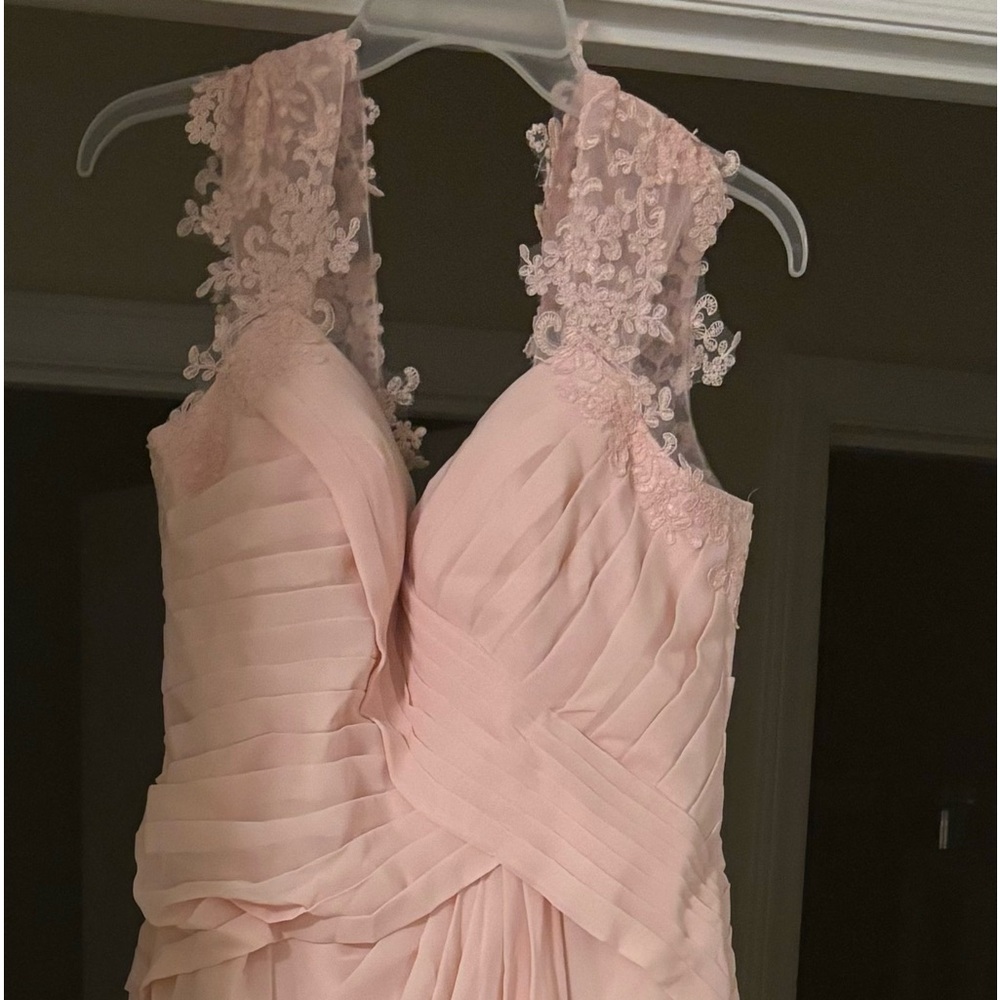 In good condition, the dress has never been worn